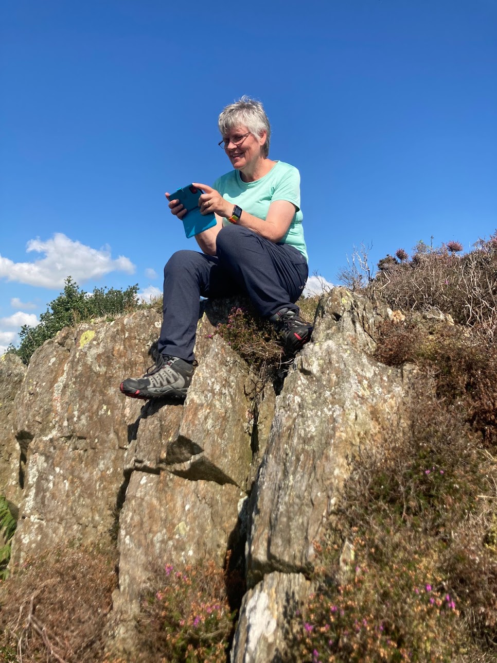 Helena sat on a rock in walking gear