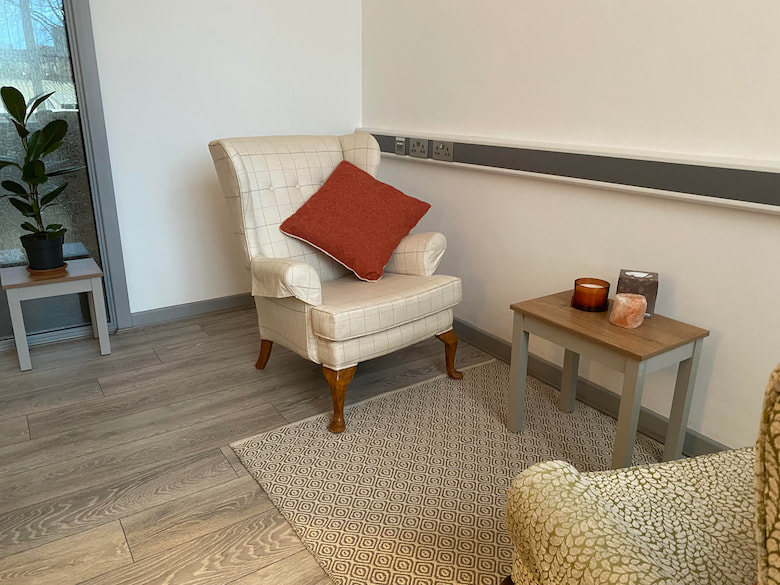A light, airy room with two armchairs